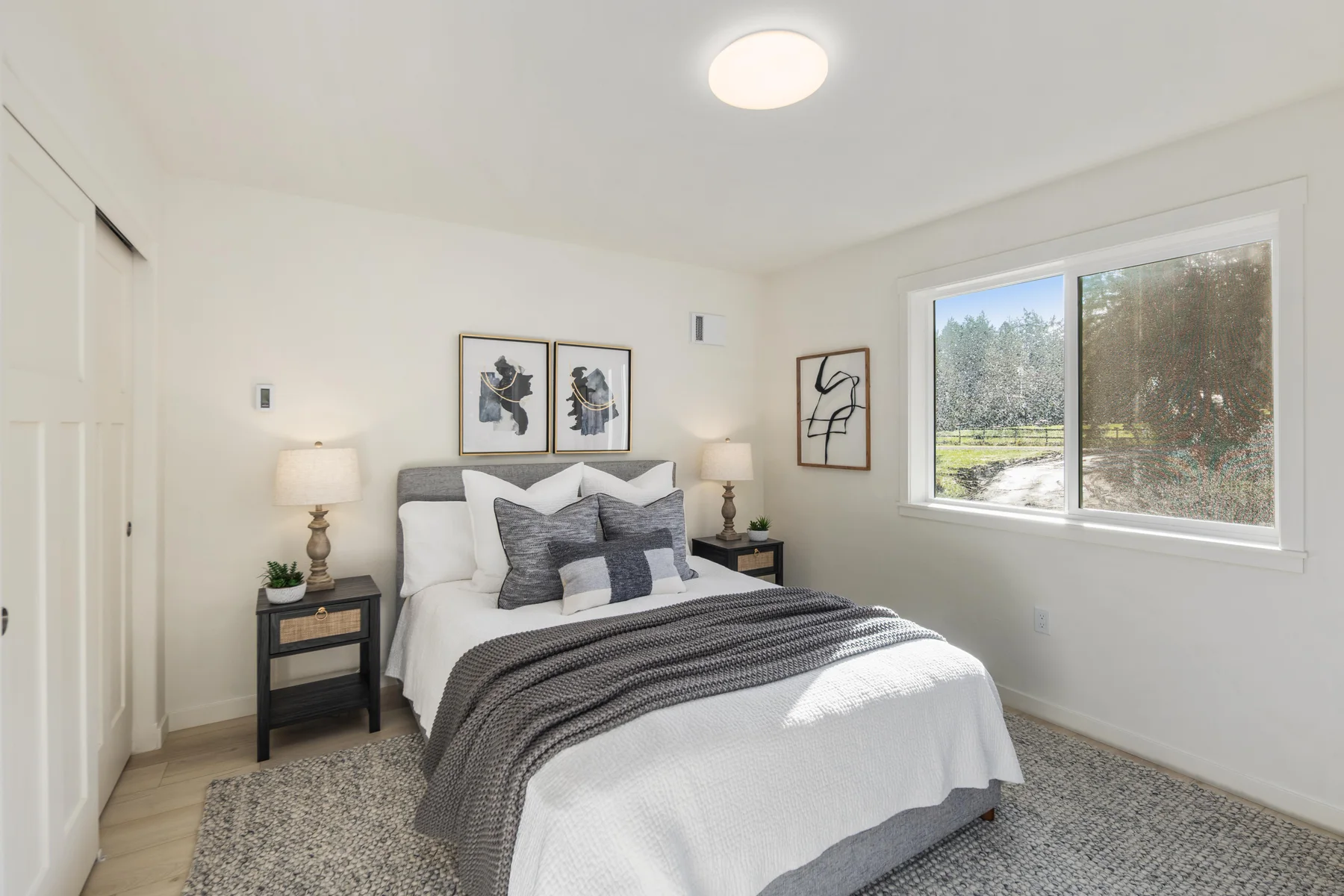 Furnished bedroom with a window overlooking trees